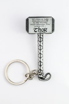 a hammer keychain with the words thor on it