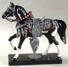 a figurine of a black and white horse with red accents on it's body