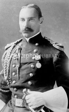 an old black and white photo of a man in uniform