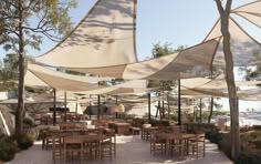 an outdoor dining area with tables and umbrellas