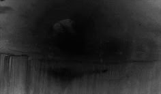 a black and white photo of a person in the dark
