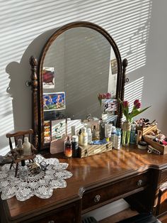 a dresser with a mirror and various items on it