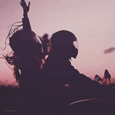 the silhouette of a person on a motorcycle