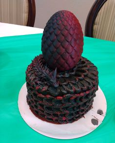 there is a cake that looks like a dragon's head on top of it