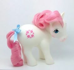 a toy pony with pink hair and blue eyes