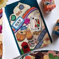 an artistic card is displayed on a table with other art supplies and crafting supplies