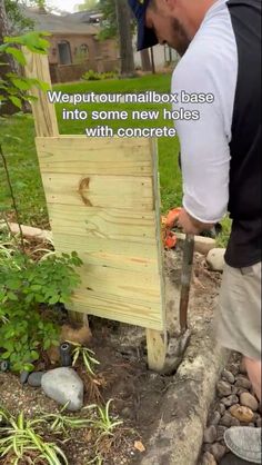 a man is working with wood to build a garden fence in his backyard, and the caption reads wont - gummibox base into some new holes with concrete