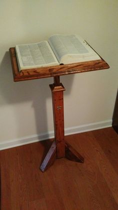 an open book sitting on top of a wooden table