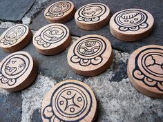 wooden buttons with designs on them sitting on the ground
