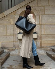 the tote that carries it all, and perhaps too much Timeless Large Capacity Tote Shoulder Bag, Big Work Bag, Chic Large Bag For Errands, Versatile Black Tote Bag, Oversized Bags, Black Large Capacity Tote Bucket Bag, Black Tote Bag Outfit, Large Tote Bag Outfit, Demellier Tote