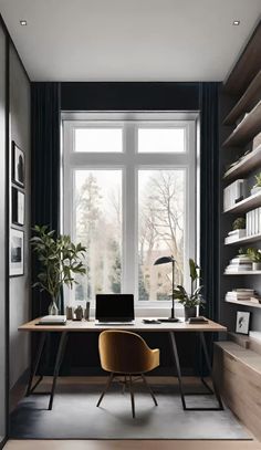 a desk with a laptop on top of it in front of a window and bookshelves