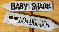 two wooden signs that say baby shark and do - do with sunglasses on each one