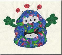 an image of a cartoon character made out of paper on a piece of white fabric