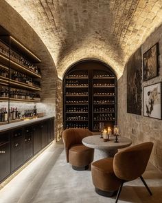 a wine cellar with two chairs and a table