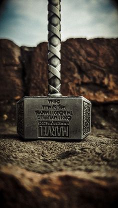 a hammer that is sitting on some rocks