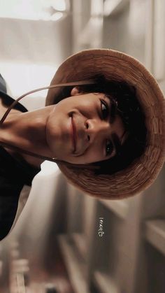 a woman wearing a hat and posing for the camera