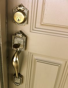an ornate door handle on a white door