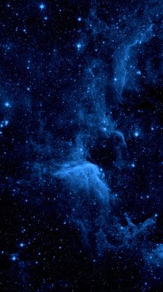 an image of the night sky with stars and blue hues on black background, taken from space