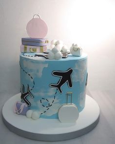 a blue and white cake with luggage on it
