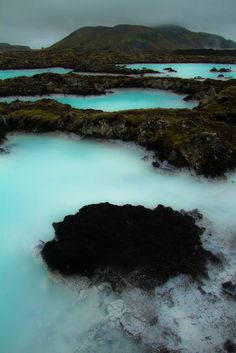 the blue lagoons are surrounded by green moss