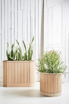 two wooden planters sitting next to each other