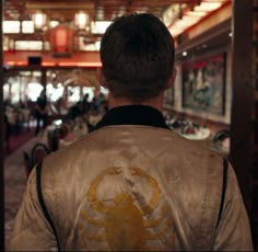 the back of a man's jacket with an image of a scorpion on it