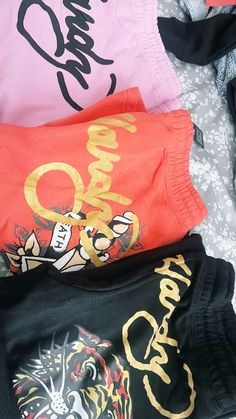three shirts are laying on top of each other