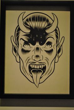 a black and white drawing of a demon with horns on it's head in a frame