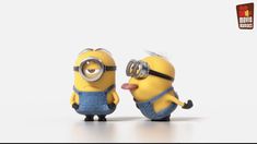 two minion figures with glasses and one sticking out its tongue to the other, both wearing overalls