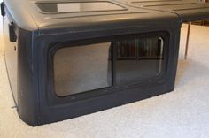 a black television set sitting on top of a carpeted floor