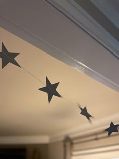 three black stars hanging from the ceiling