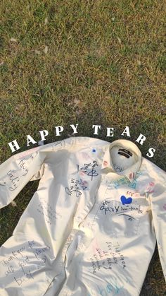 a white shirt with writing on it sitting in the grass