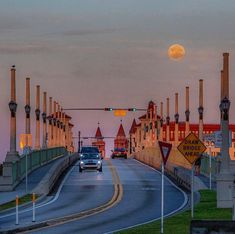 a car driving down the road in front of a traffic light