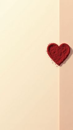 a red heart shaped powder on top of a white wall