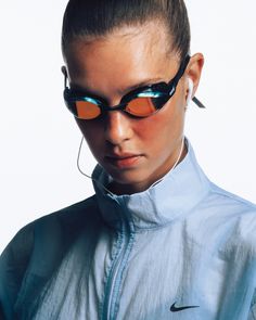 a woman with sunglasses on her head wearing a blue jacket