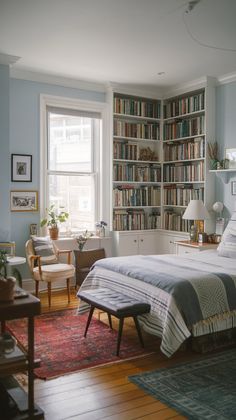 a bedroom with a bed, chair and bookshelf full of bookcases
