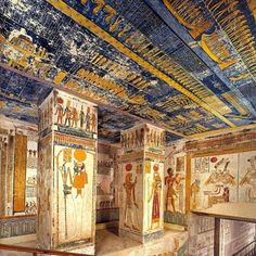 an ancient room with paintings on the ceiling