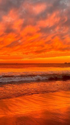 an orange and red sunset over the ocean