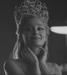 black and white photograph of a woman wearing a tiara with her hands on her face