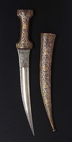 two knives are sitting next to each other on a black surface, one is gold and the other is silver