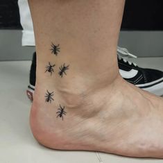 Stand out with this quirky ant trail ankle tattoo! Featuring detailed, minimalist ants in a playful arrangement, this tattoo symbolizes teamwork and resilience. Perfect for anyone looking for a unique and meaningful ink idea. Pin this creative design for your next tattoo inspiration! Trail Of Ants Tattoo, Line Of Ants Tattoo, Simple Ankle Tattoos, Rose Tattoo On Ankle, Ant Tattoo, Ankle Tattoo Designs, Anklet Tattoos, Vine Tattoos, Flower Outline