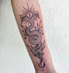 a black and white snake tattoo on the right arm, with stars in the background