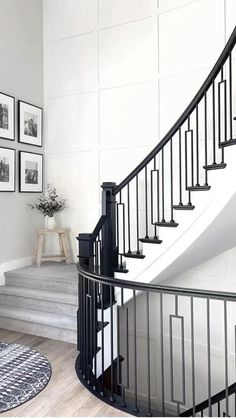 a black and white staircase with pictures on the wall