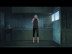 a person standing in a dark kitchen looking out the window