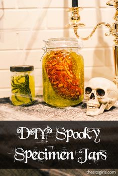 a table topped with jars filled with liquid and a skull head next to each other