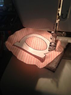 the sewing machine is working on the fabric that has been sewn in it's place
