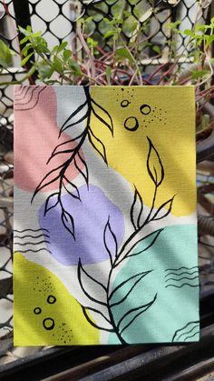 a piece of art that is on top of a metal table next to a fence