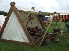 an old fashioned tent is set up in the grass