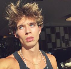 a young man with his hair in the air