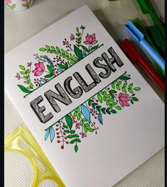 an english coloring book surrounded by markers and pencils